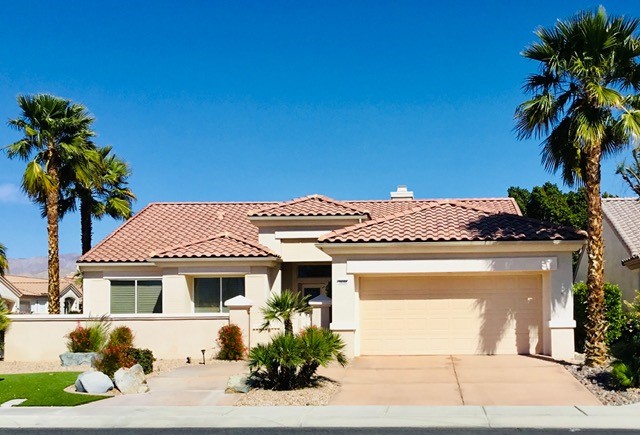 Well-maintained single-story residential home with two-car garage and desert landscaping, ideal for homebuyers in a suburban neighborhood.